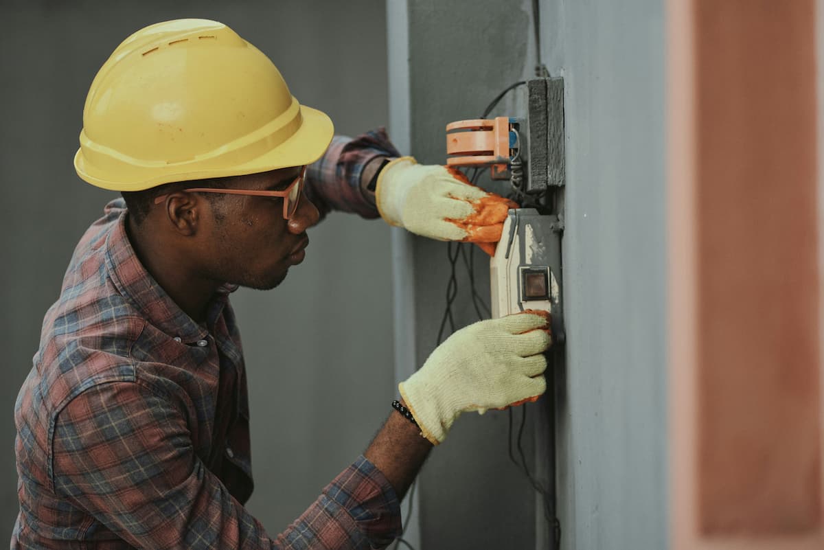 Licensed electrician inspecting electrical panel
